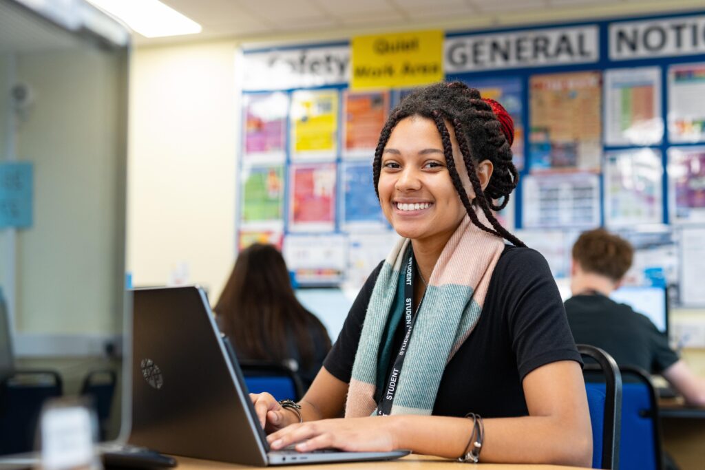 Student smiling at computer