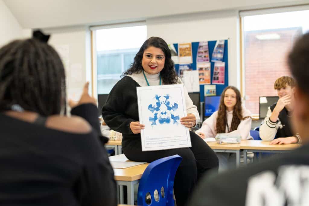 teacher showing an ink blot to students